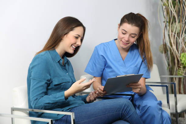 Nurse explaining medical procedure to a patient in a waiting room