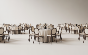 Elegant indoor party setup with banquet chairs and tables in a stylish event hall