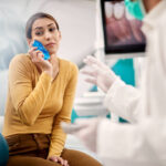 Women with ice pack to sooth tooth ache