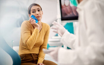 Women with ice pack to sooth tooth ache
